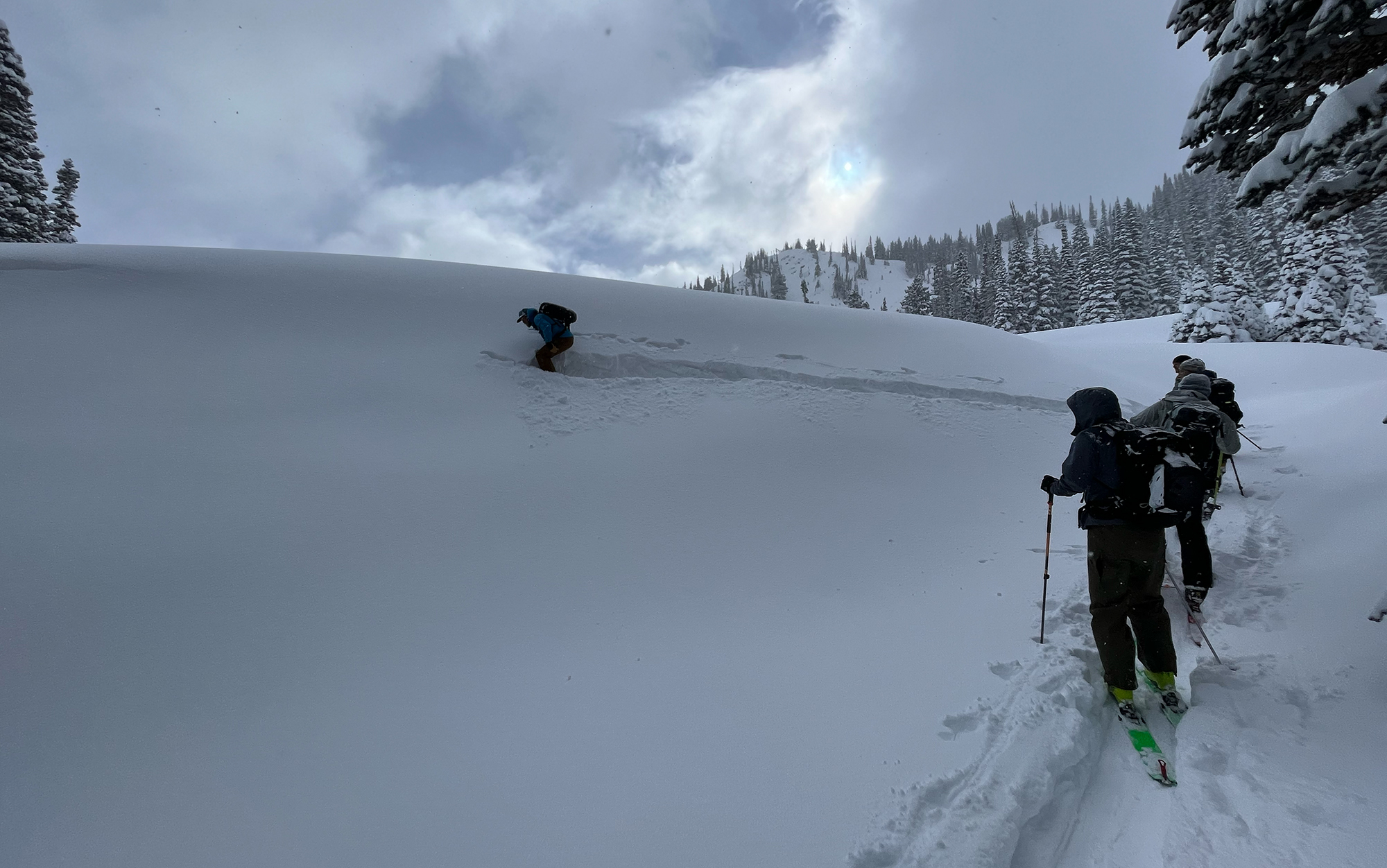 Our instructor attempts to trigger an avalanche on a test slope, a small piece of inconsequential terrain that is indicative of where we are trying to ski.
