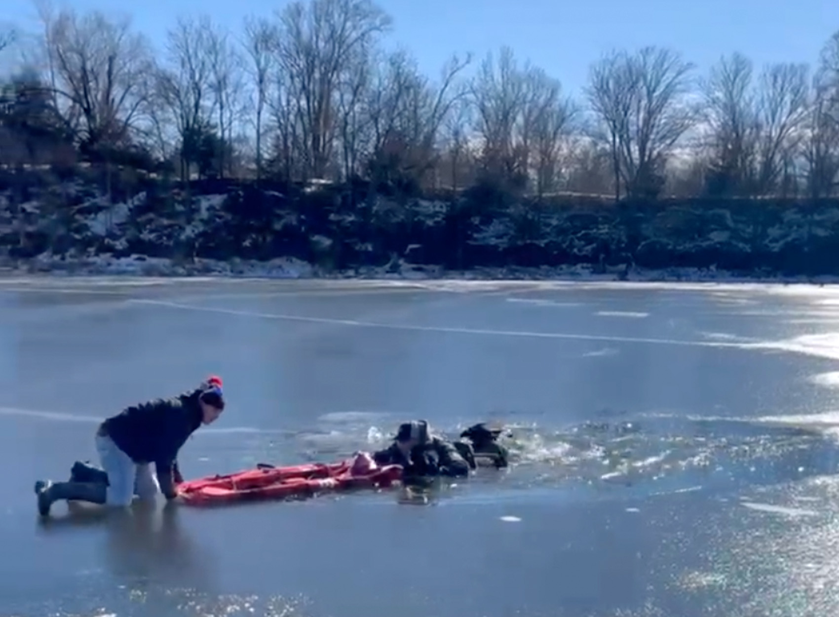 An ice fisherman rescues a fellow angler using a tent bag.