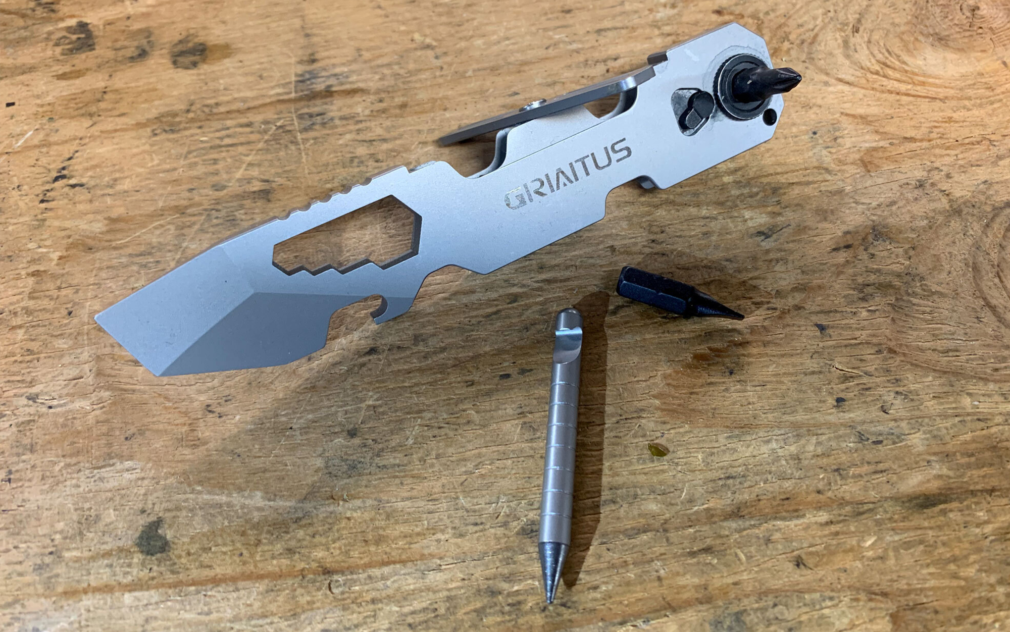 The Griaitus Multitool Pry Bar features a pointed wedge pry bar, multi-sized wrench function, Phillips and flat bits, reversible ratcheting driver, magnetic “eternity pen/pencil,” pocket clip, and bottle opener.