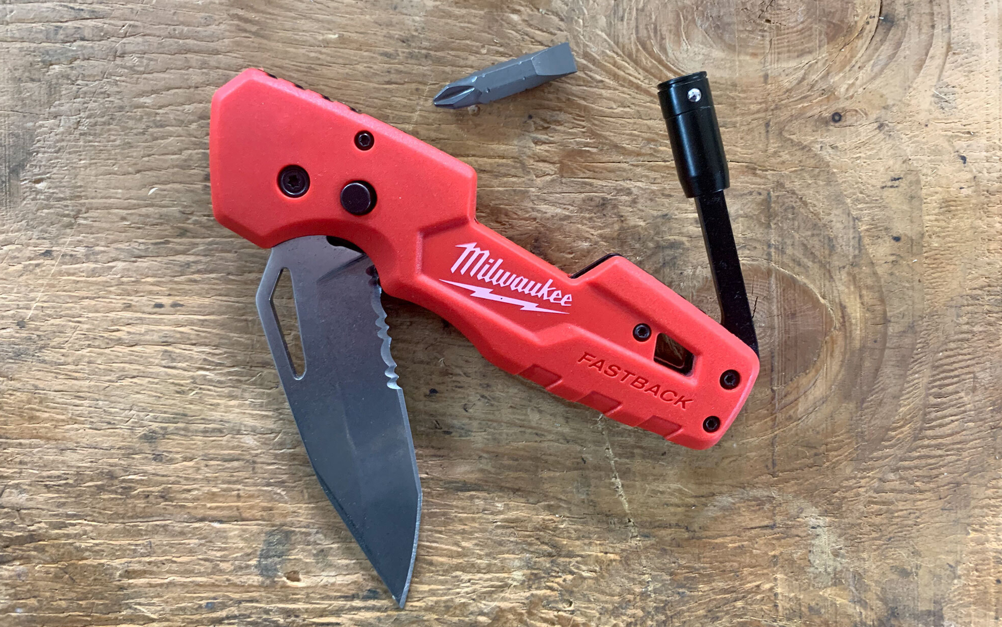 The Milwaukee Fastback 5-in-1 features a knife blade, fold-out ¼-inch bit driver, two-sided flat and Phillips bit, bottle opener, and flip-out blade with safety button.