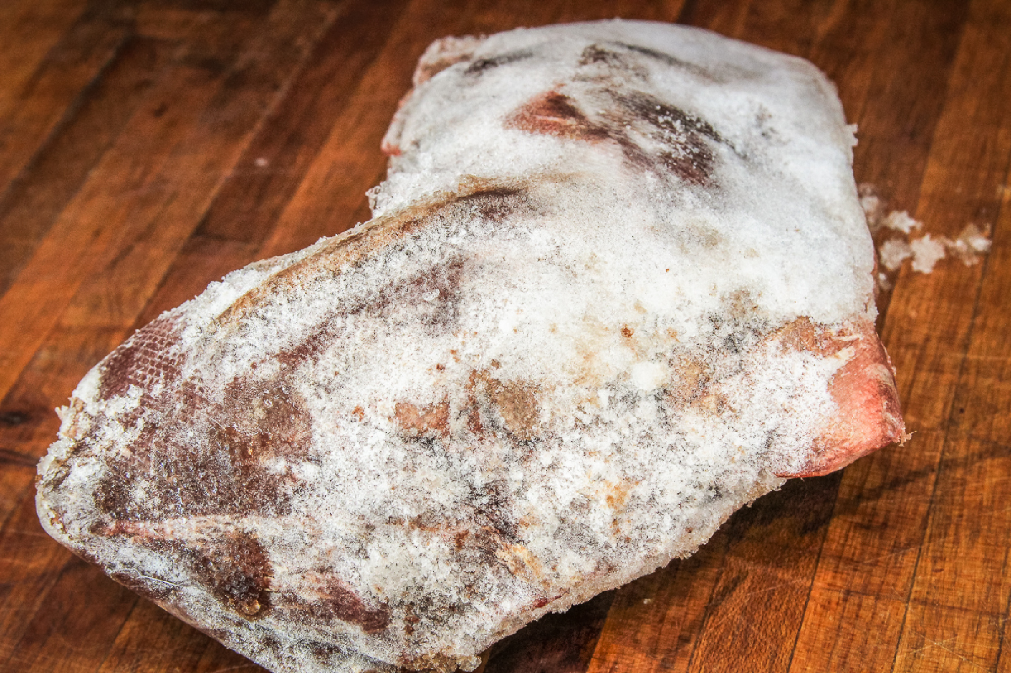 A piece of meat is covered in serious freezer burn.