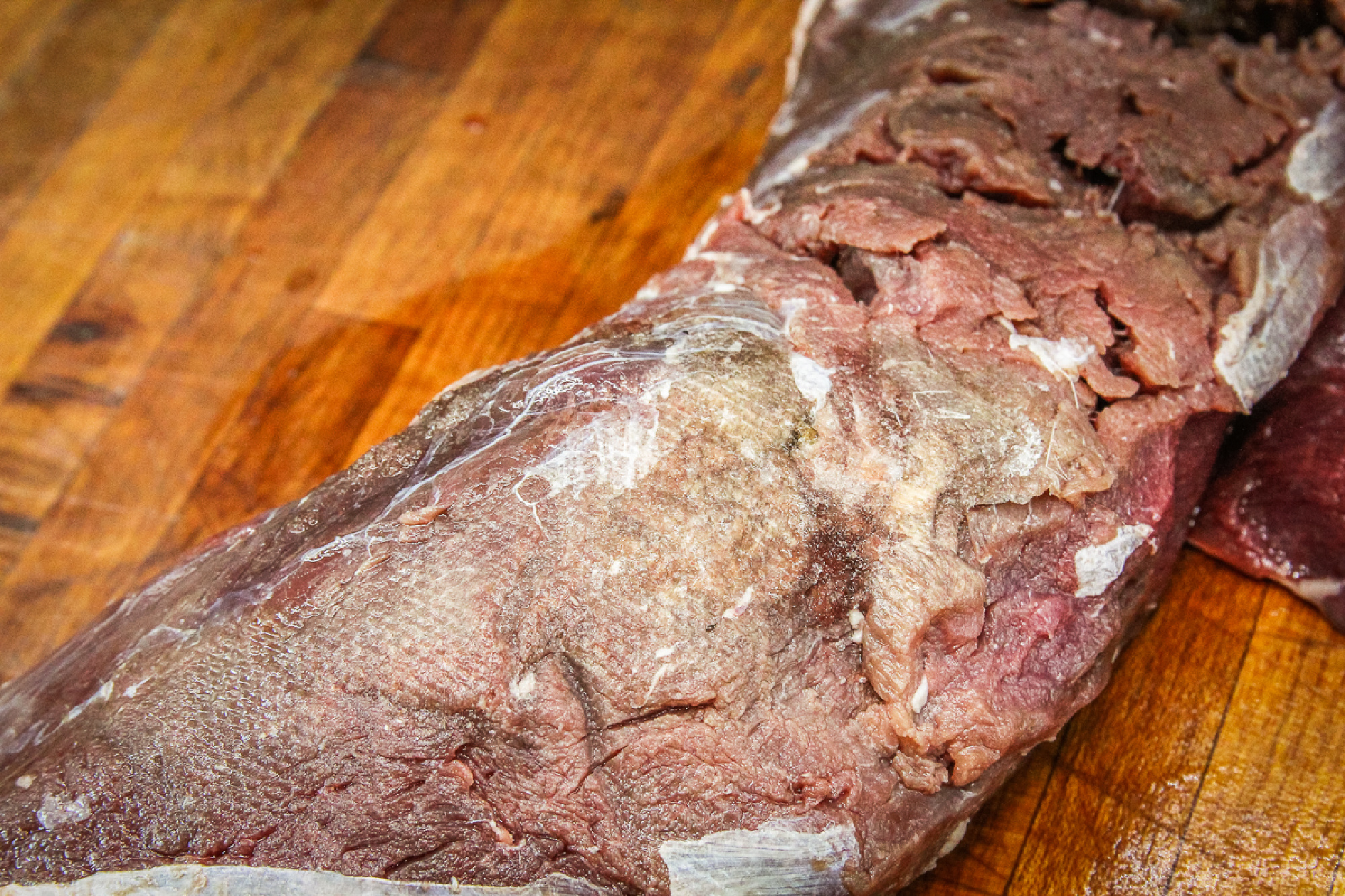 A section of meat shows signs of freezer burn.