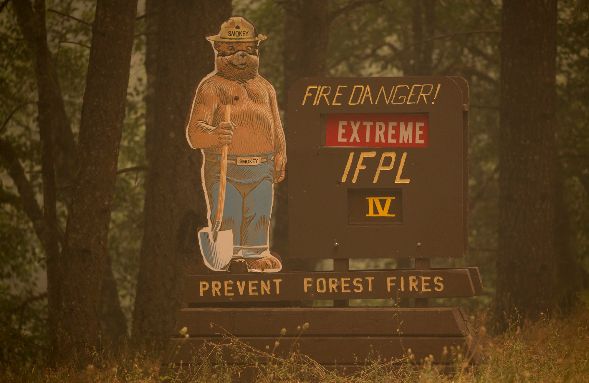 A sign with Smoky the Bear warns of fire risk.