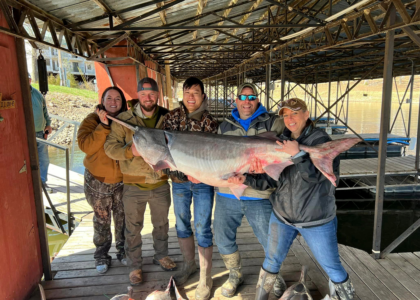 A group of anglers hold up the world-record paddlefish.