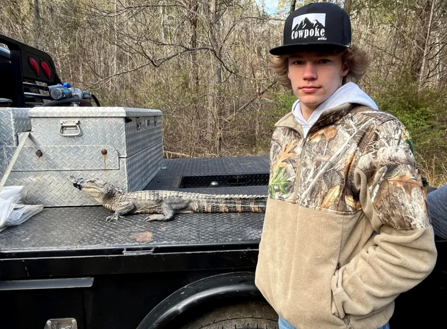 A Tennessee angler with a gator he caught from a lake.