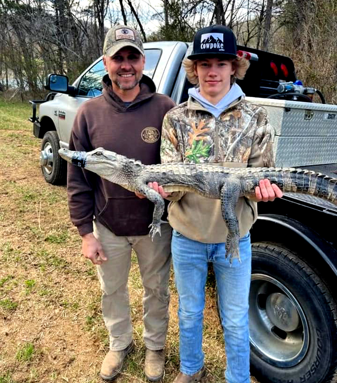A 16-year-old Tennessee angler holds up an alligator.