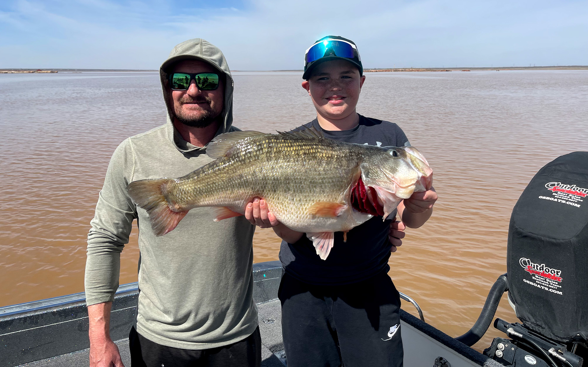 A young angler and his dad with a giant Texas largemouth.