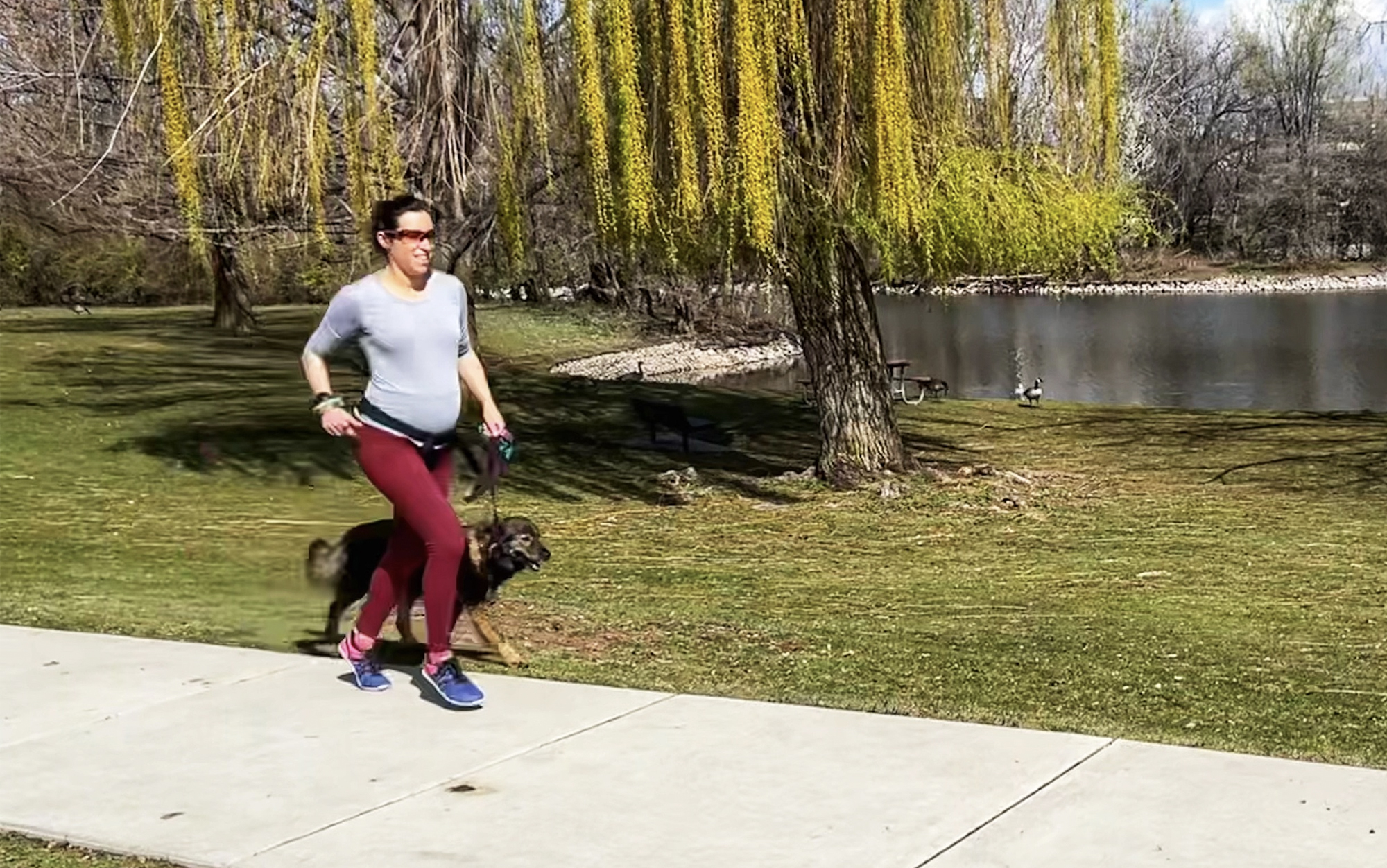 Pregnant woman running in barefoot shoes.