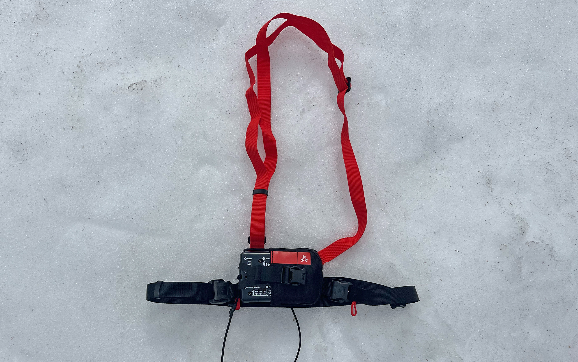 The Arva Neo BT Pro harness sits in the snow.