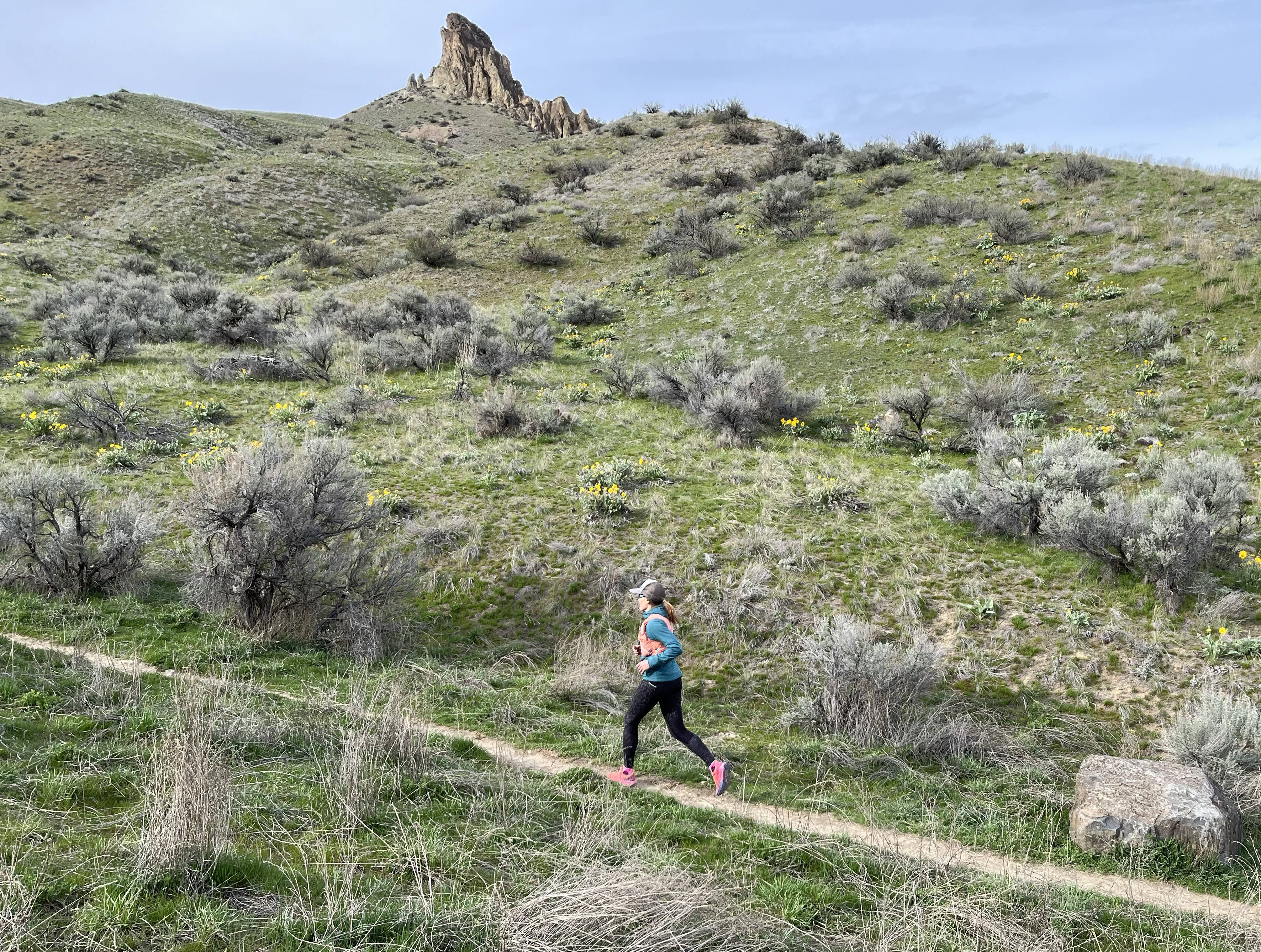 Woman runs in the Speedgoat 5s.