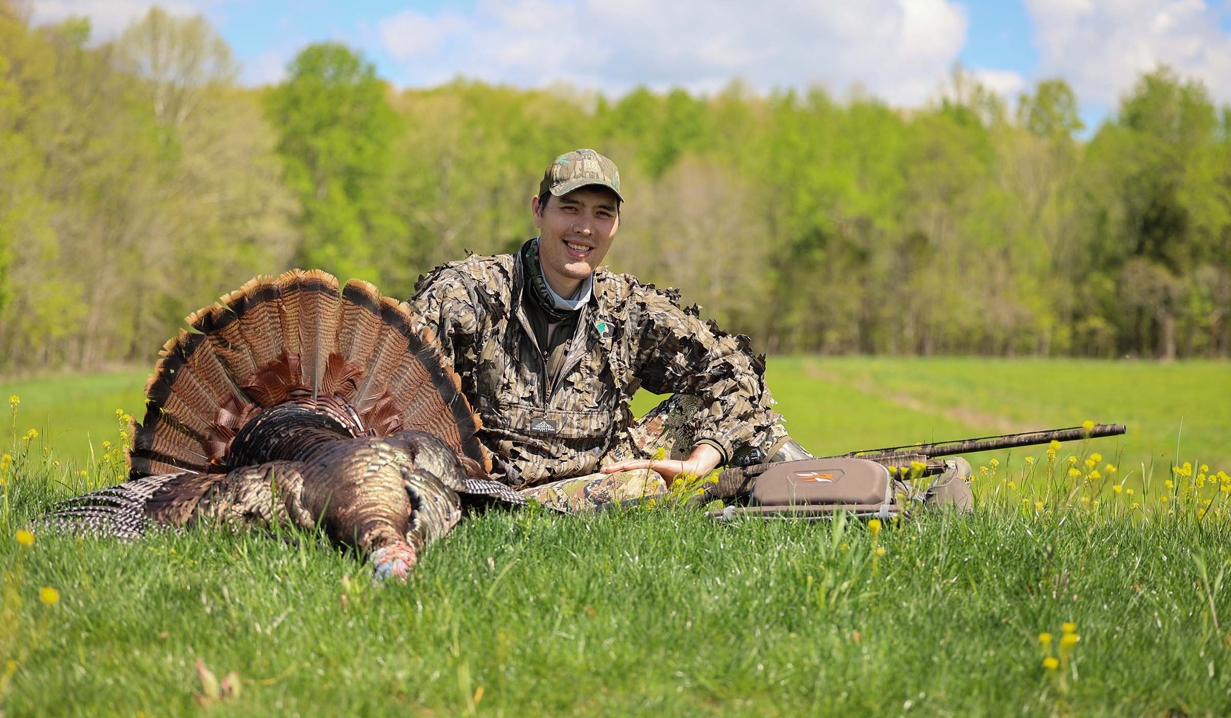 A hunter sits behind a longbeard and besid the Benelli M2
