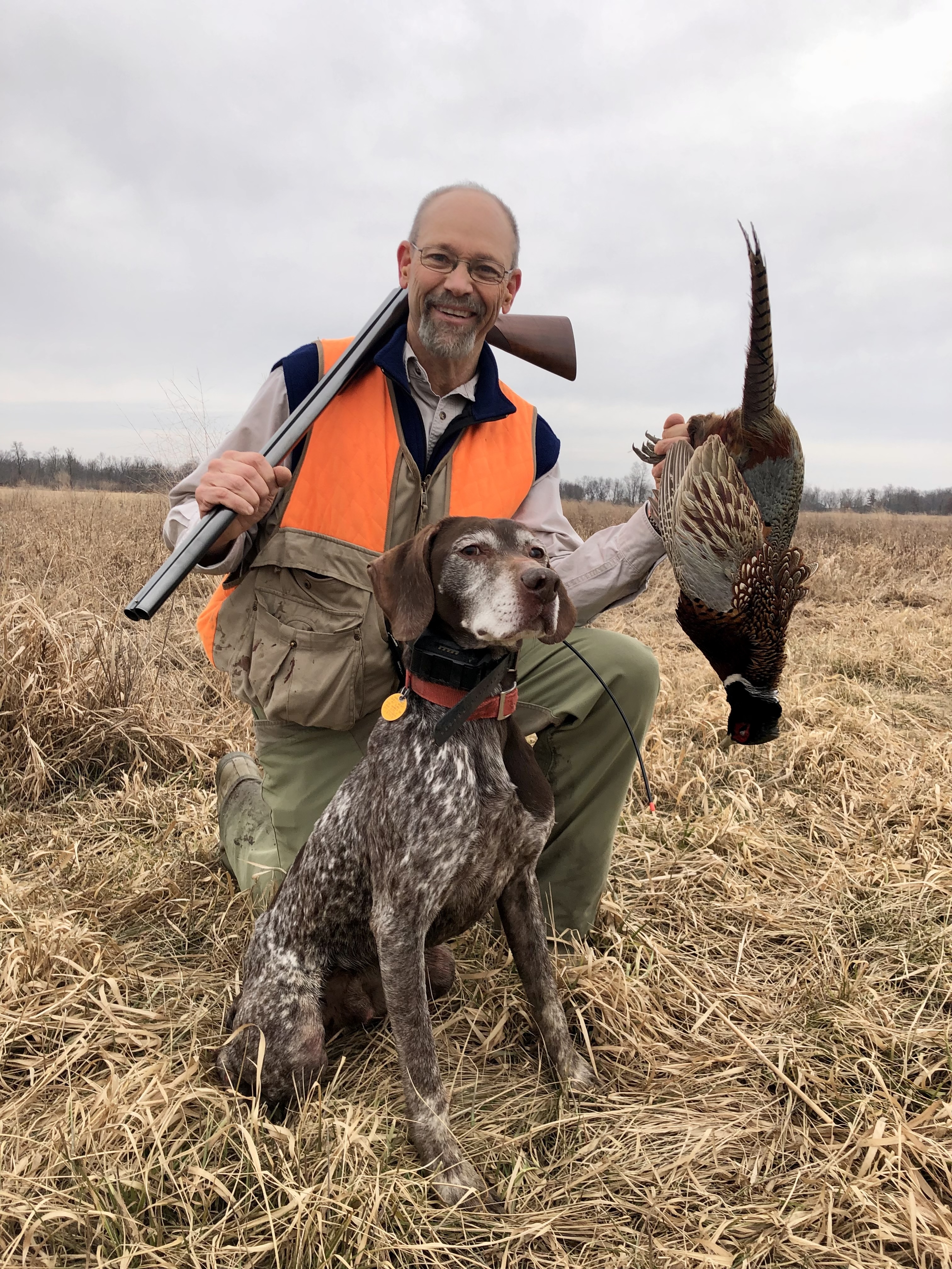 An Iowa hunter and his bird dog