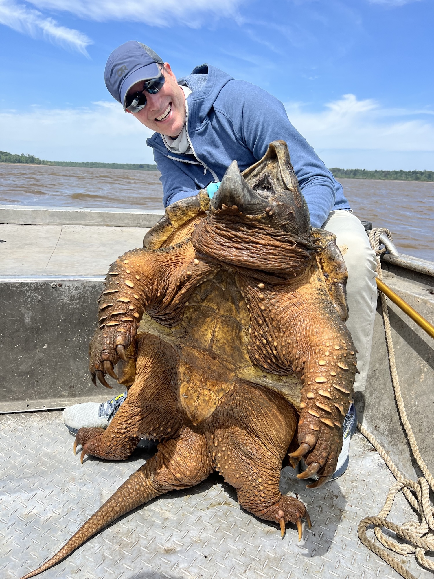 Angler with an enormous alligator snapping turtle.