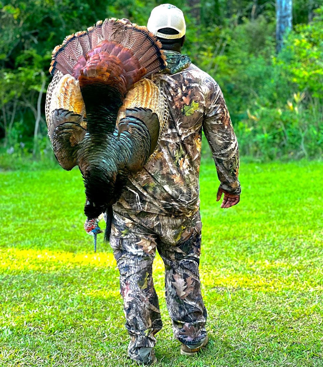 A Georgia hunter carries a wild turkey.