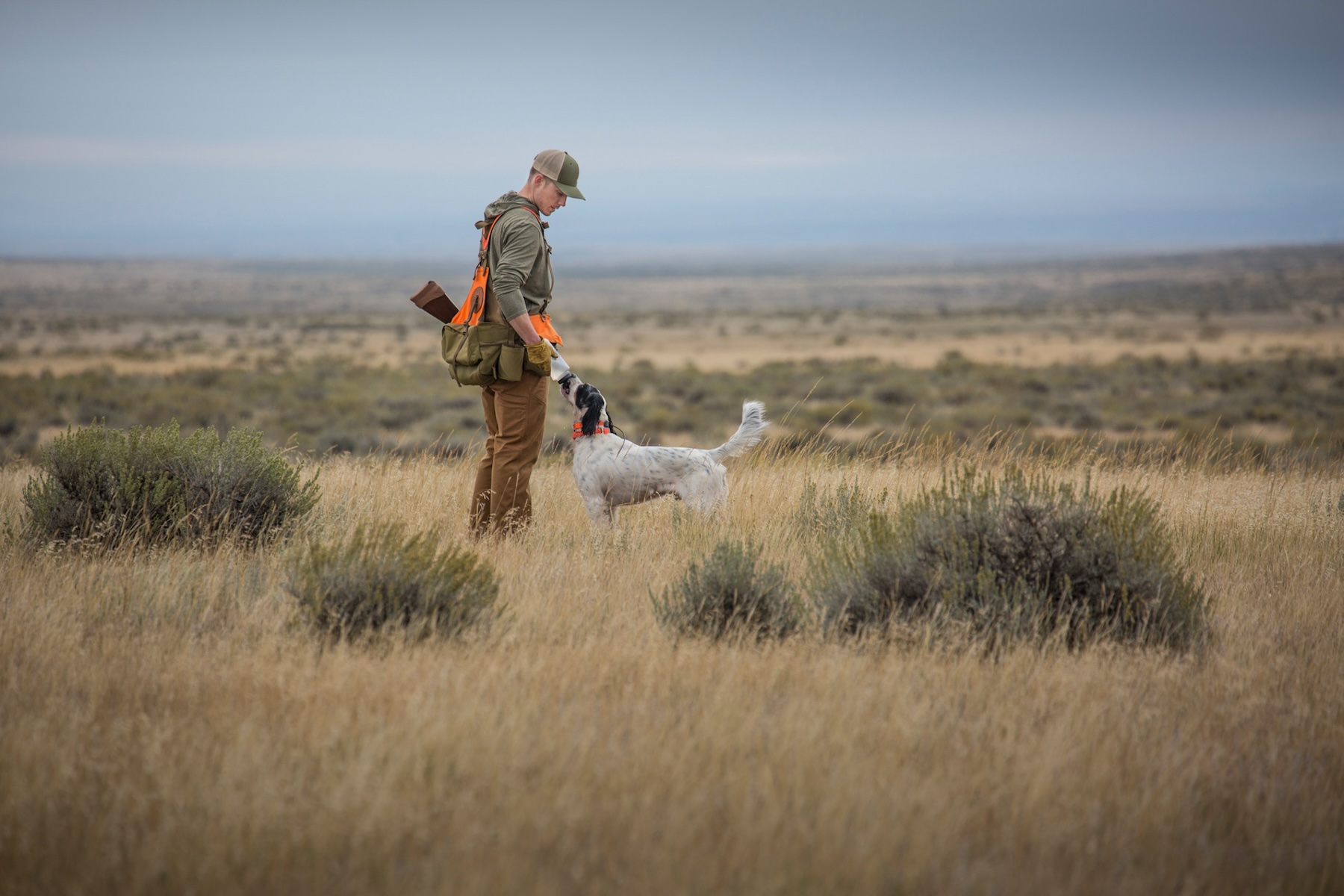A hunter waters his setter.