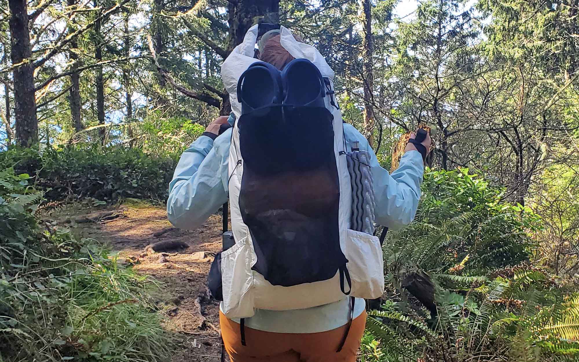 woman hiking through forest with the crop on the OV CS40 backpack