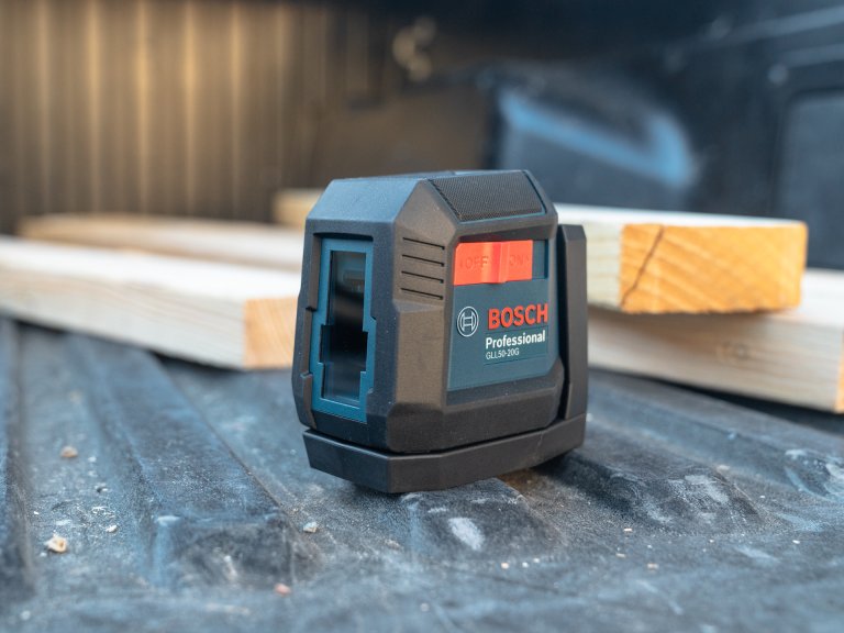 Bosch laser level sits on truck bed.