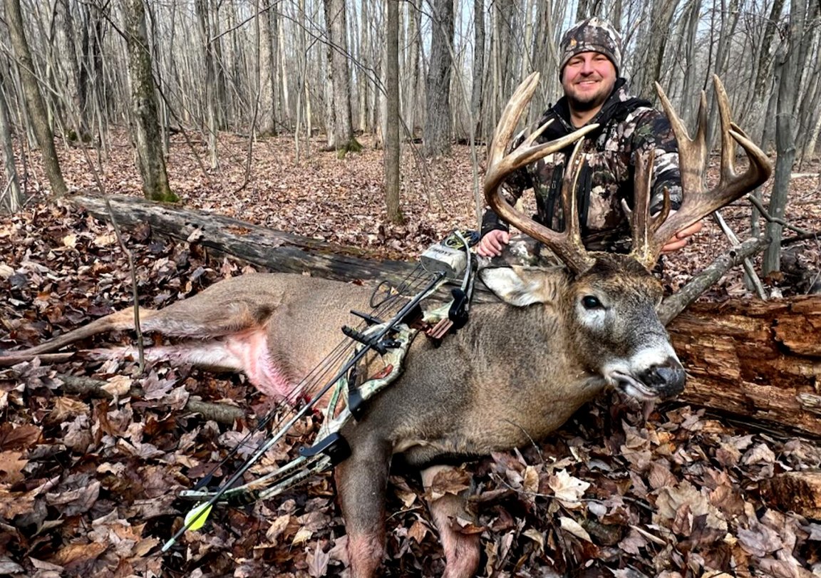 A bowhunter with a 16-point buck.