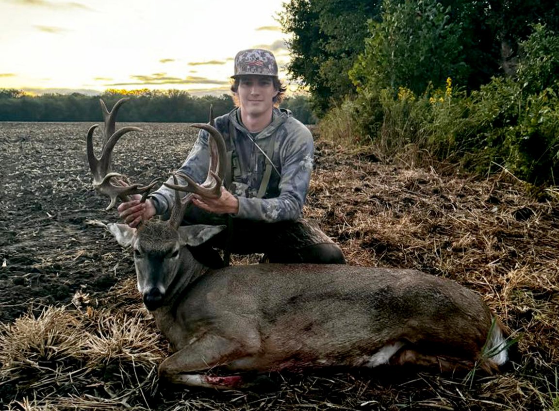 A college freshman with his first bow buck.