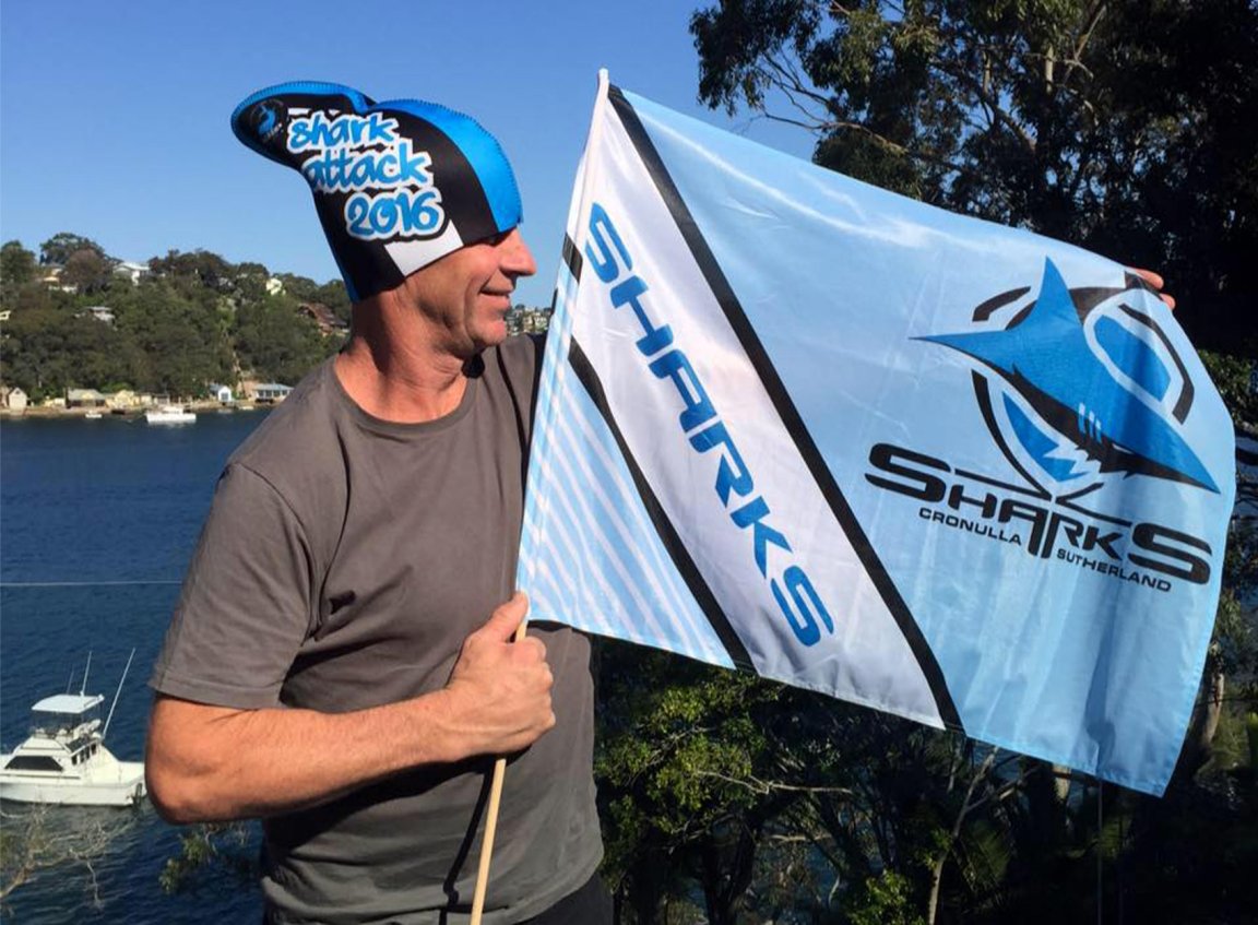 Australian angler Paul Barning, who was lost at sea, holds up a flag.