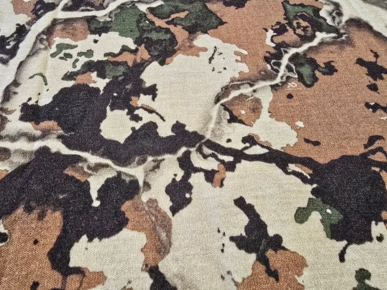 A close-up of First Lite Fusion camo pattern.