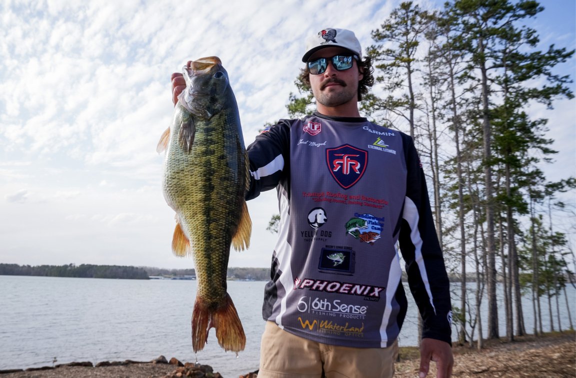 A tournament angler holds up a lake-record spotted bass.