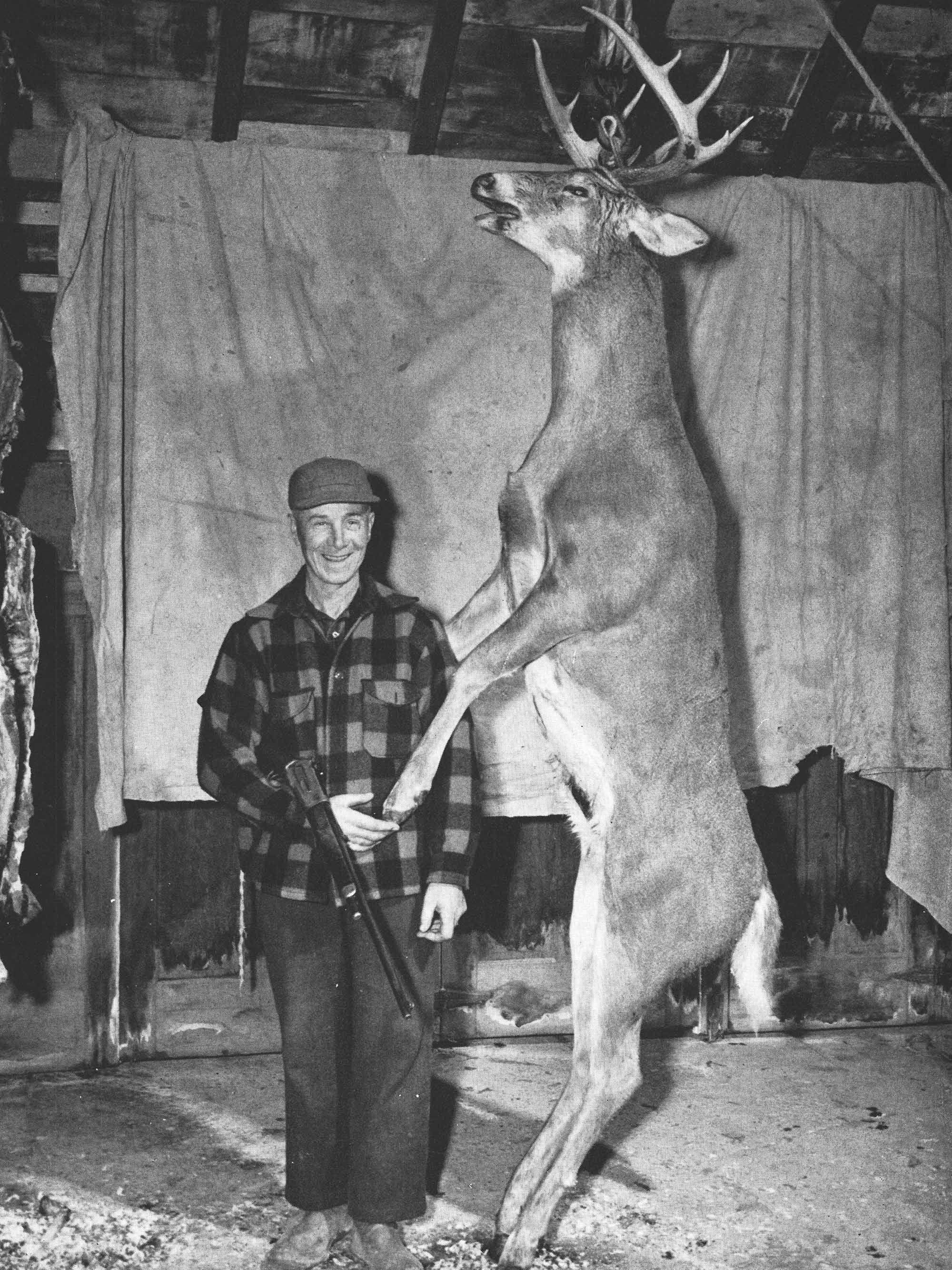 Horace Hinkley stands beside his heavy maine buck
