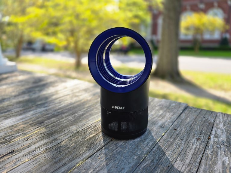 A mosquito trap sits on a backyard deck.