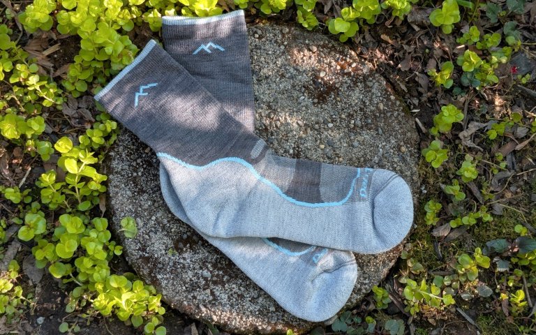 Darn Tough Lightweight socks sitting on a round stone