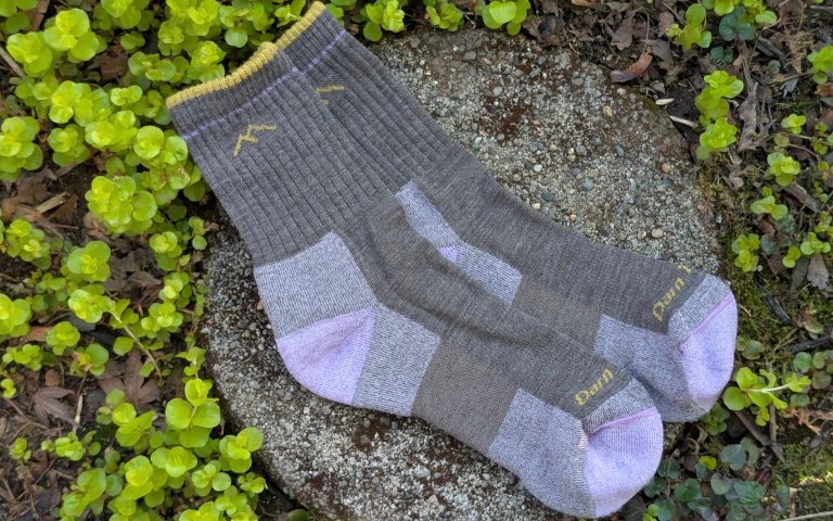 Darn Tough Midweight socks sitting on a round stone