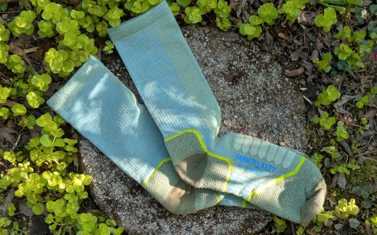 Farm to Feet Damascus Light socks sitting on a round stone