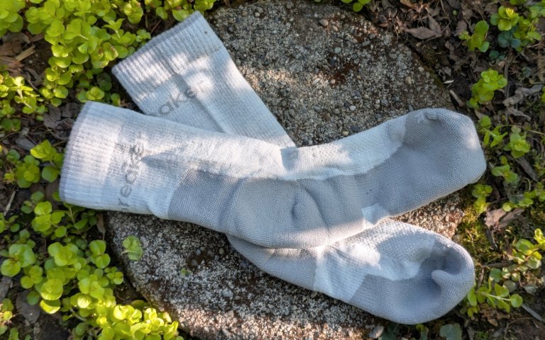 Icebreaker socks sitting on a round stone