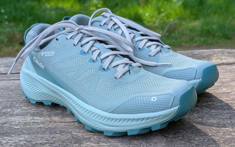 Oboz Katabatic sitting on a wooden bench