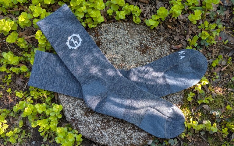 Paka socks sitting on a round stone