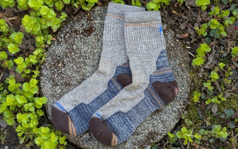 Smartwool Hike socks sitting on a round stone