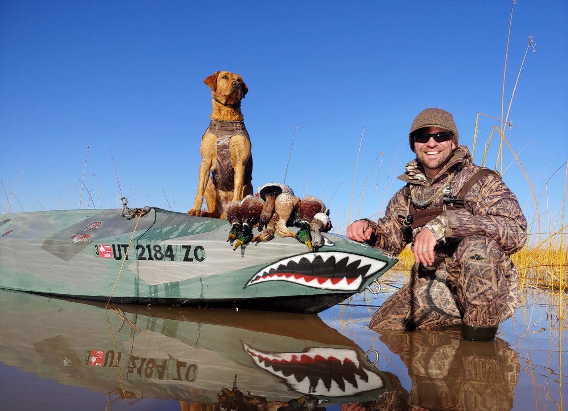 A Utah duck hunter and his Lab out on the water.
