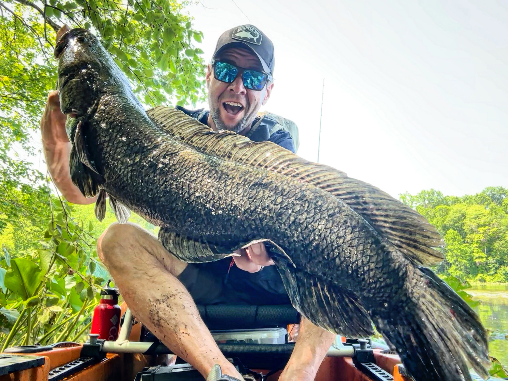 Joe Cermele, Outdoor Life's fishing editor, holds up a snakehead.