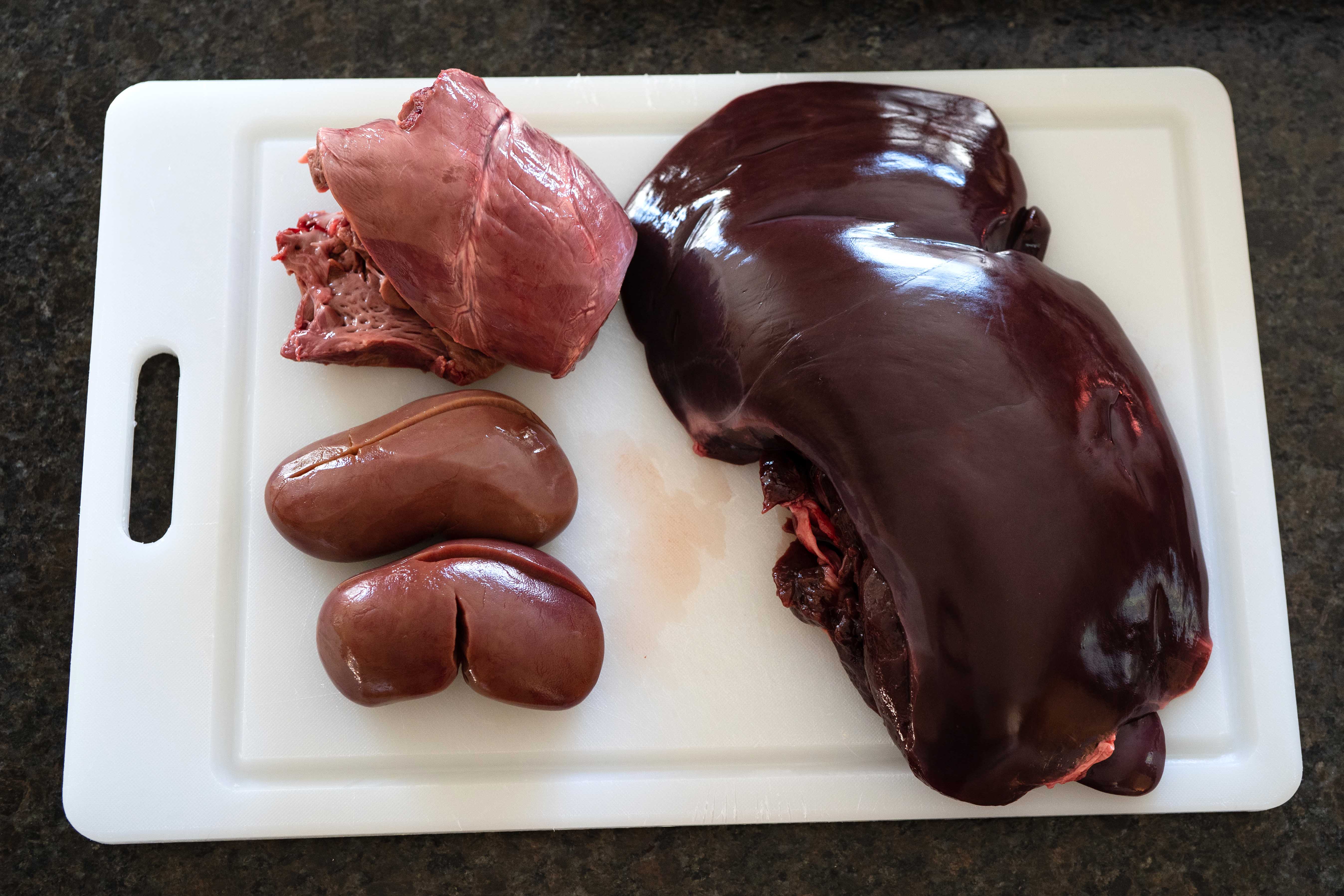 Cutting board with deer liver and kidneys