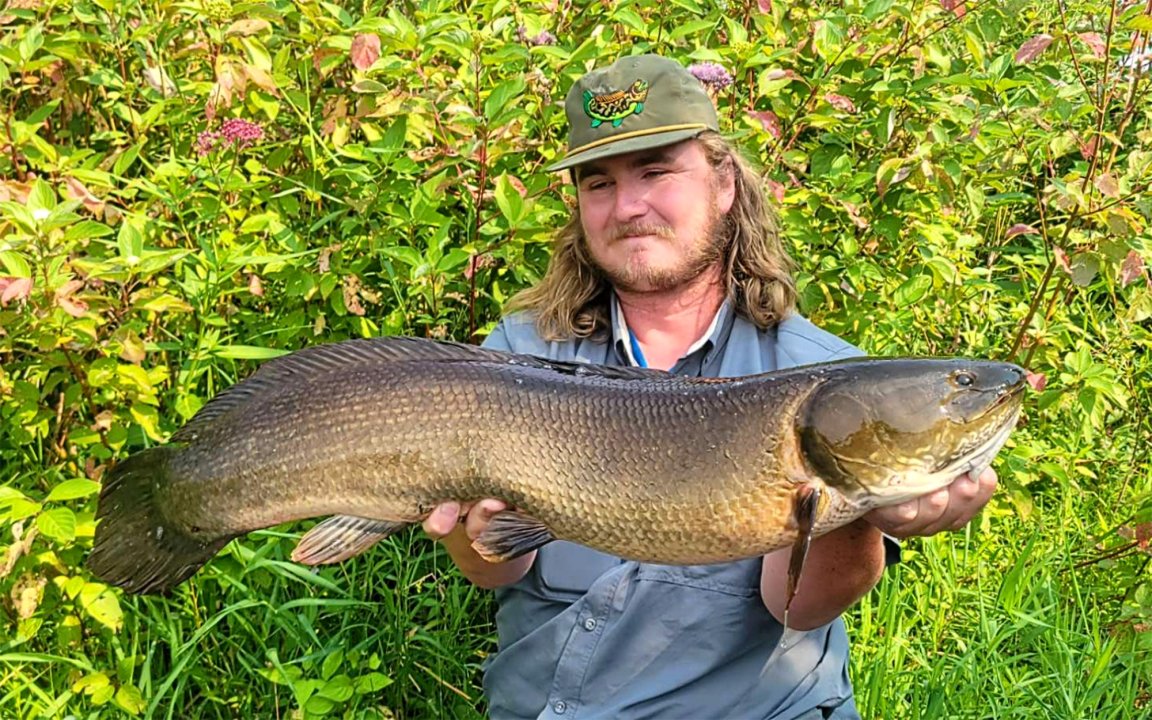 A Minnesota kayak fisherman with a state-record bowfin.