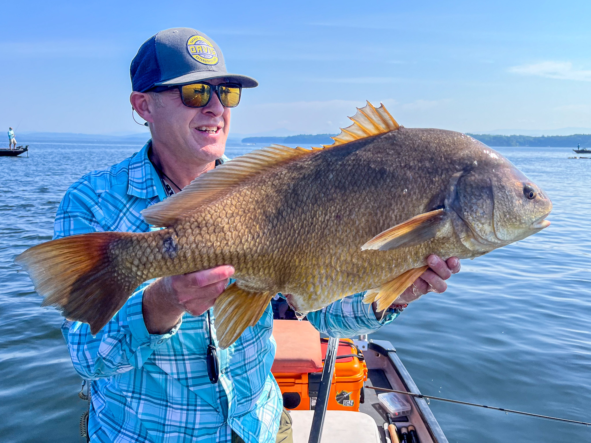 A man holds up a nice freshwater drum.