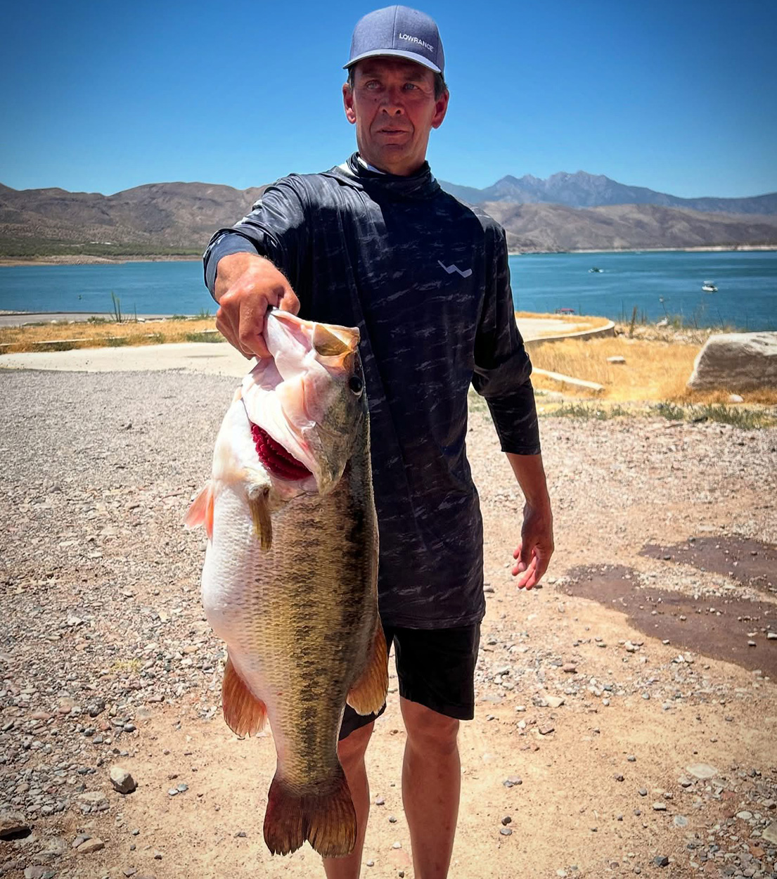 An angler holds up a monster largemouth bass in Arizona.