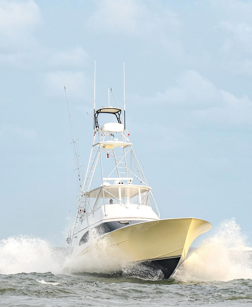 A sportfishing yacht heads out on the open ocean.