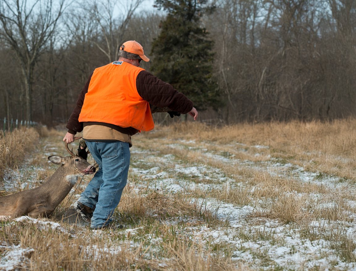 Man dragging deer