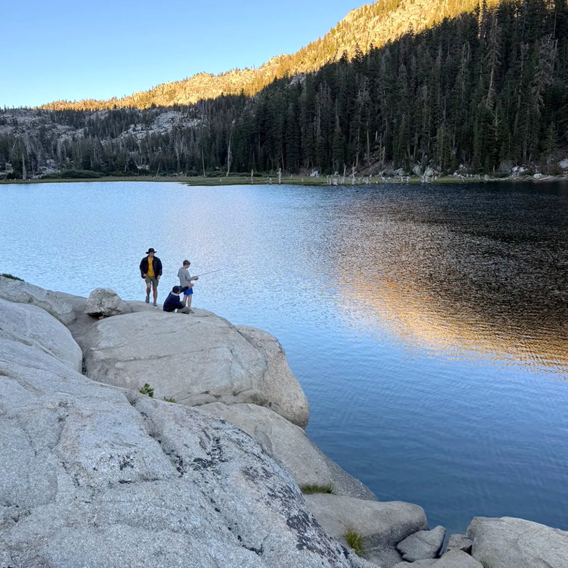 Boy scouts fishing in a wilderness lake.