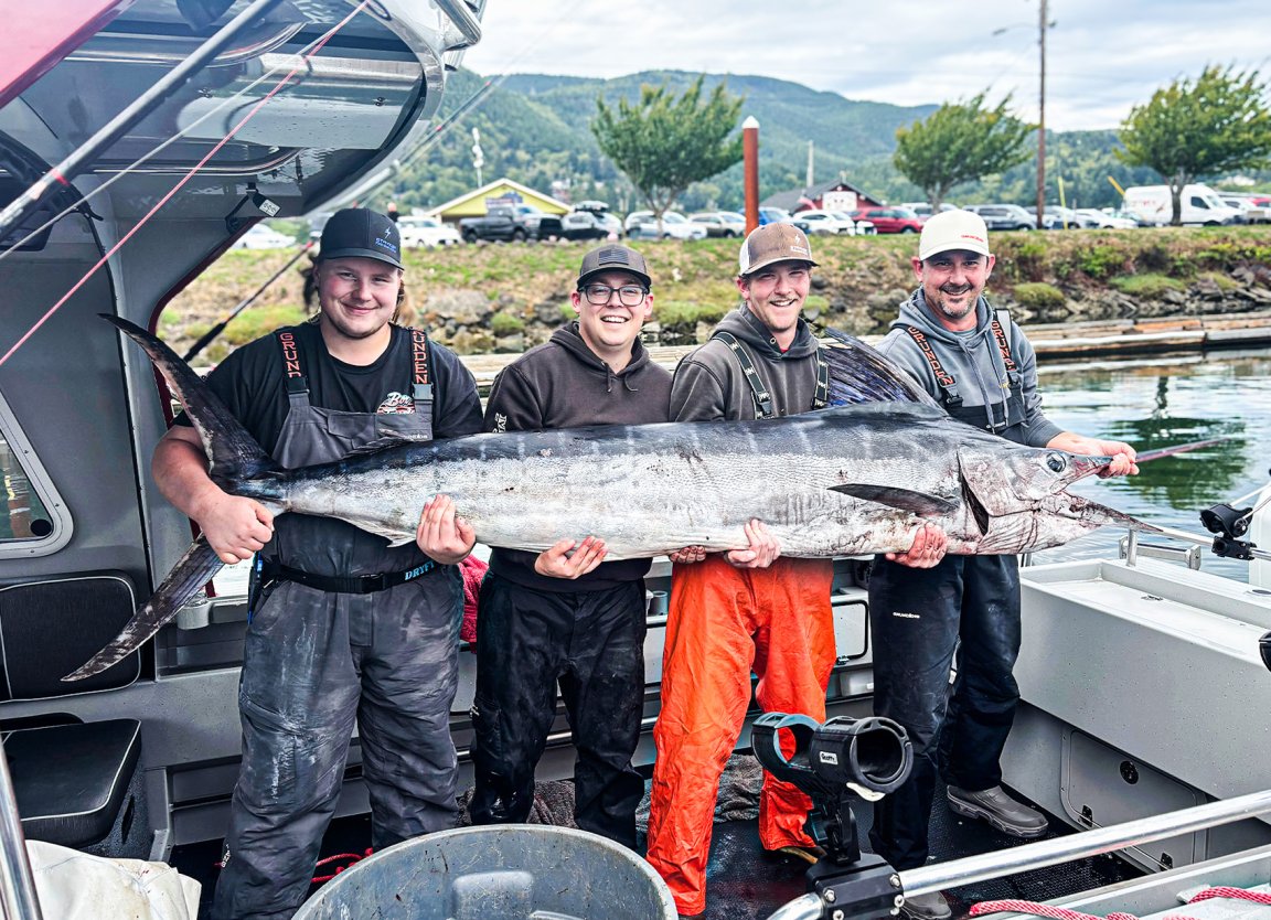 Four anglers hold up a giant striped marlin in Oregon.