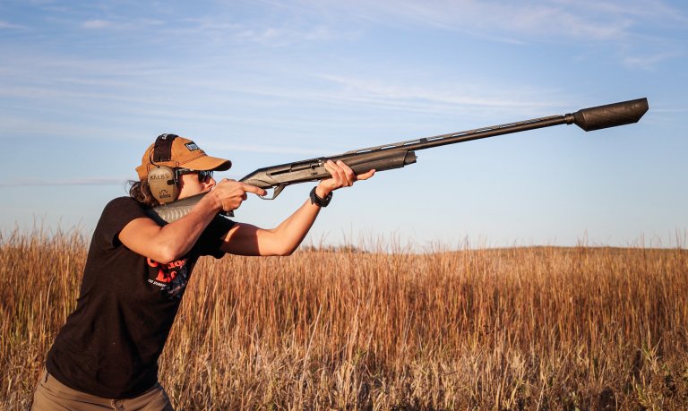 A shooter shooting an SBE3 shotgun with a banish 12 can.