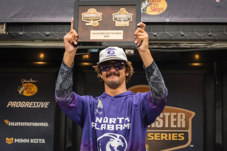 A college angler holds up his plaque after winning the Bassmaster College Bracket.