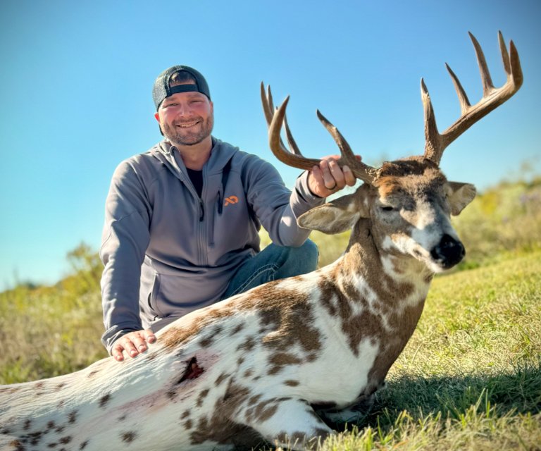 A bowhunter with a rare piebald buck taken in Ohio.