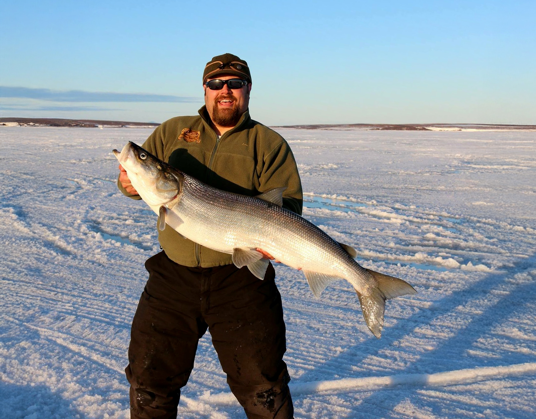 Lew Pagel holds up a big sheefish