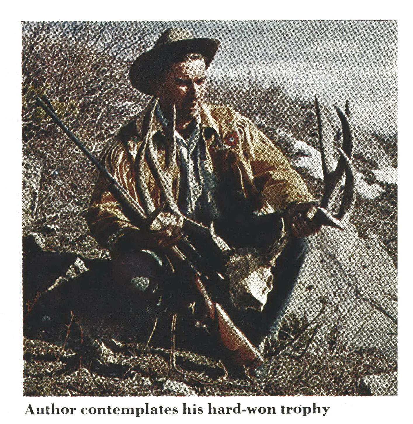 An old photo of a man with a nice mule deer buck.